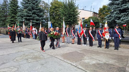 Delegacje z wieńcami – hołd złożony Zesłańcom Sybiru Kolumna delegacji z wieńcami idzie między pocztami sztandarowymi